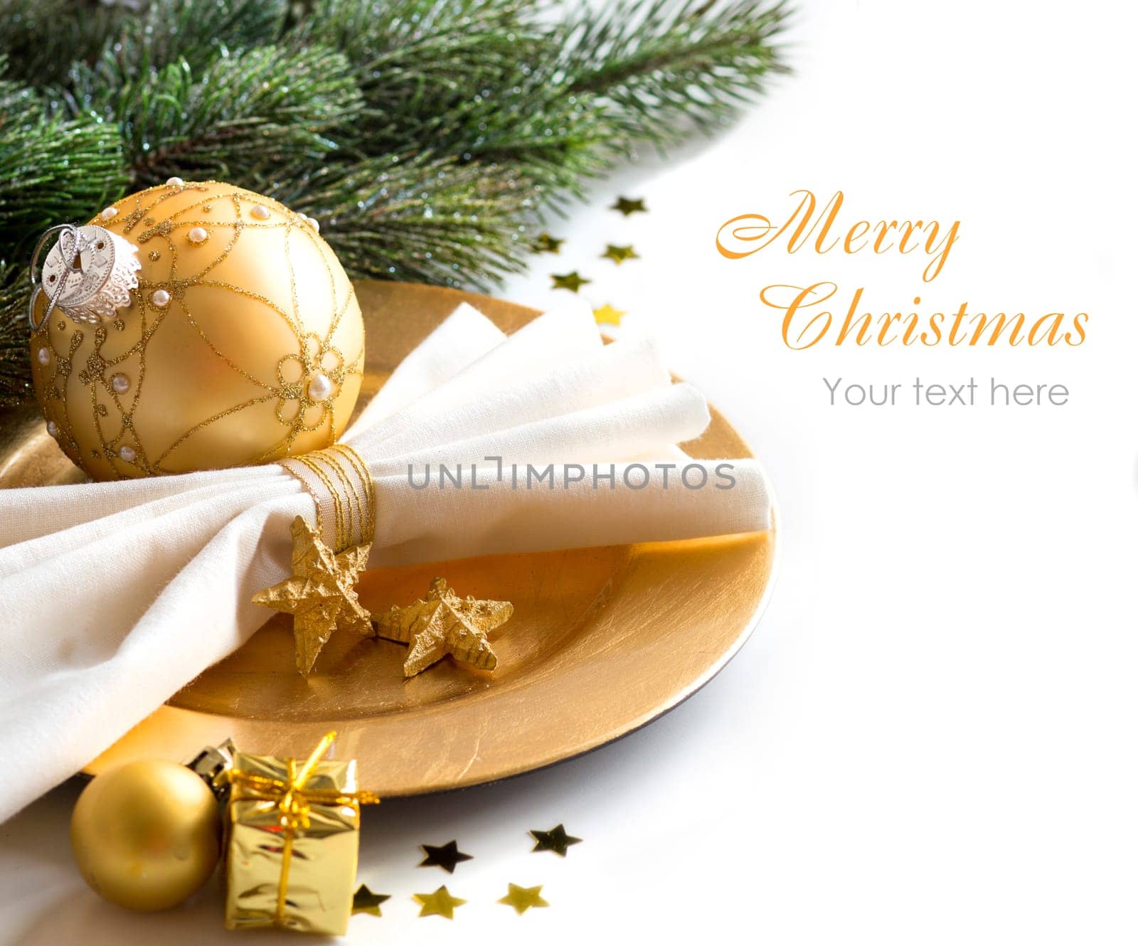 Festive table setting with golden bauble and plate