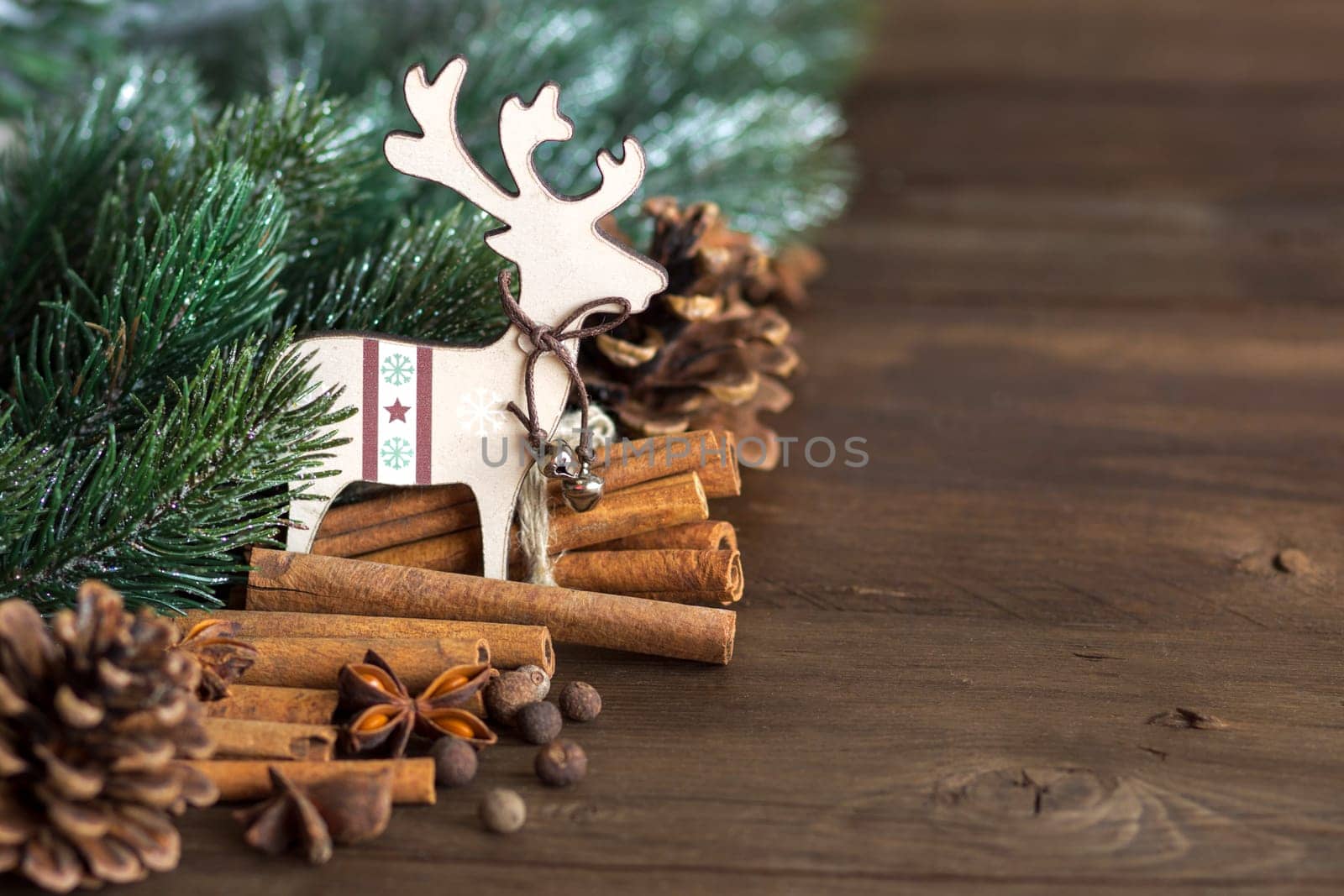 Christmas background with tree branch, spices, pine cones and deer