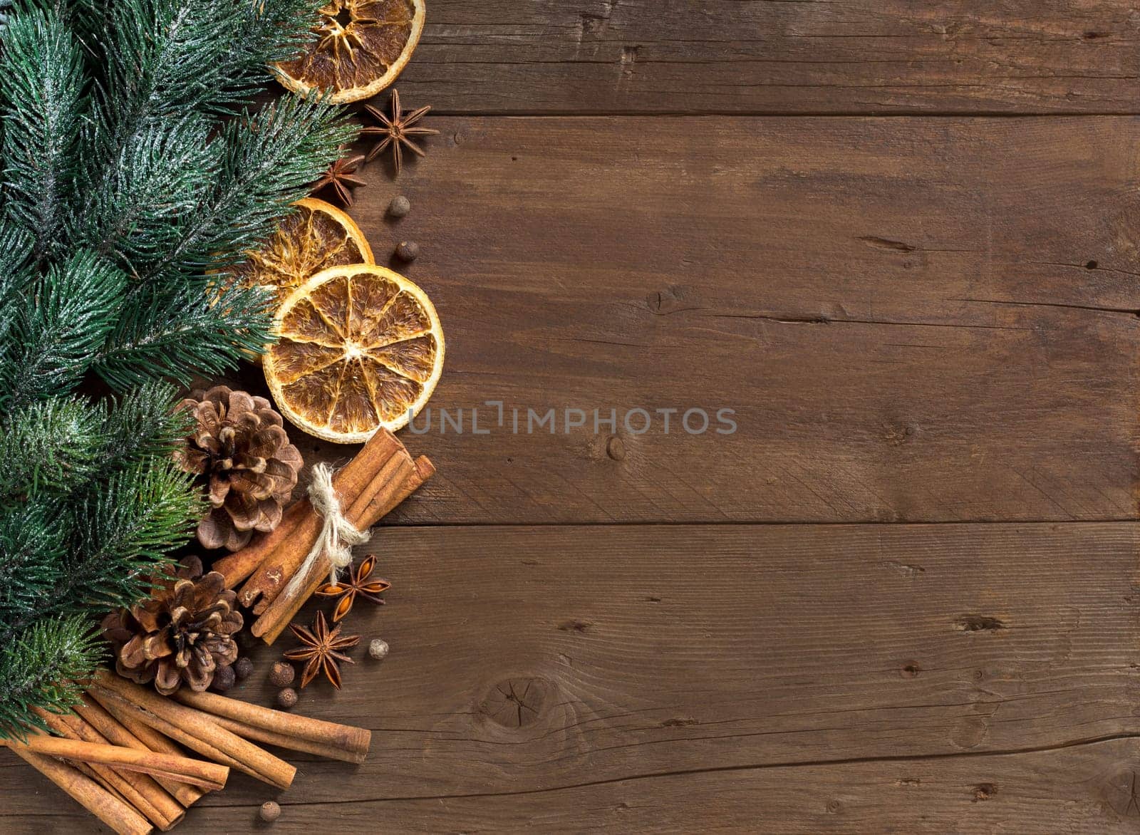Christmas composition with spices and branches on wood