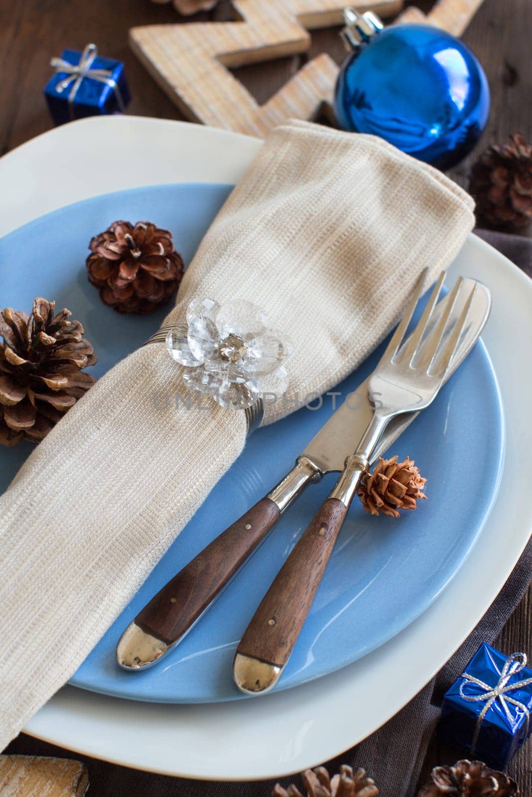 Christmas table setting with rustic decorations on wood