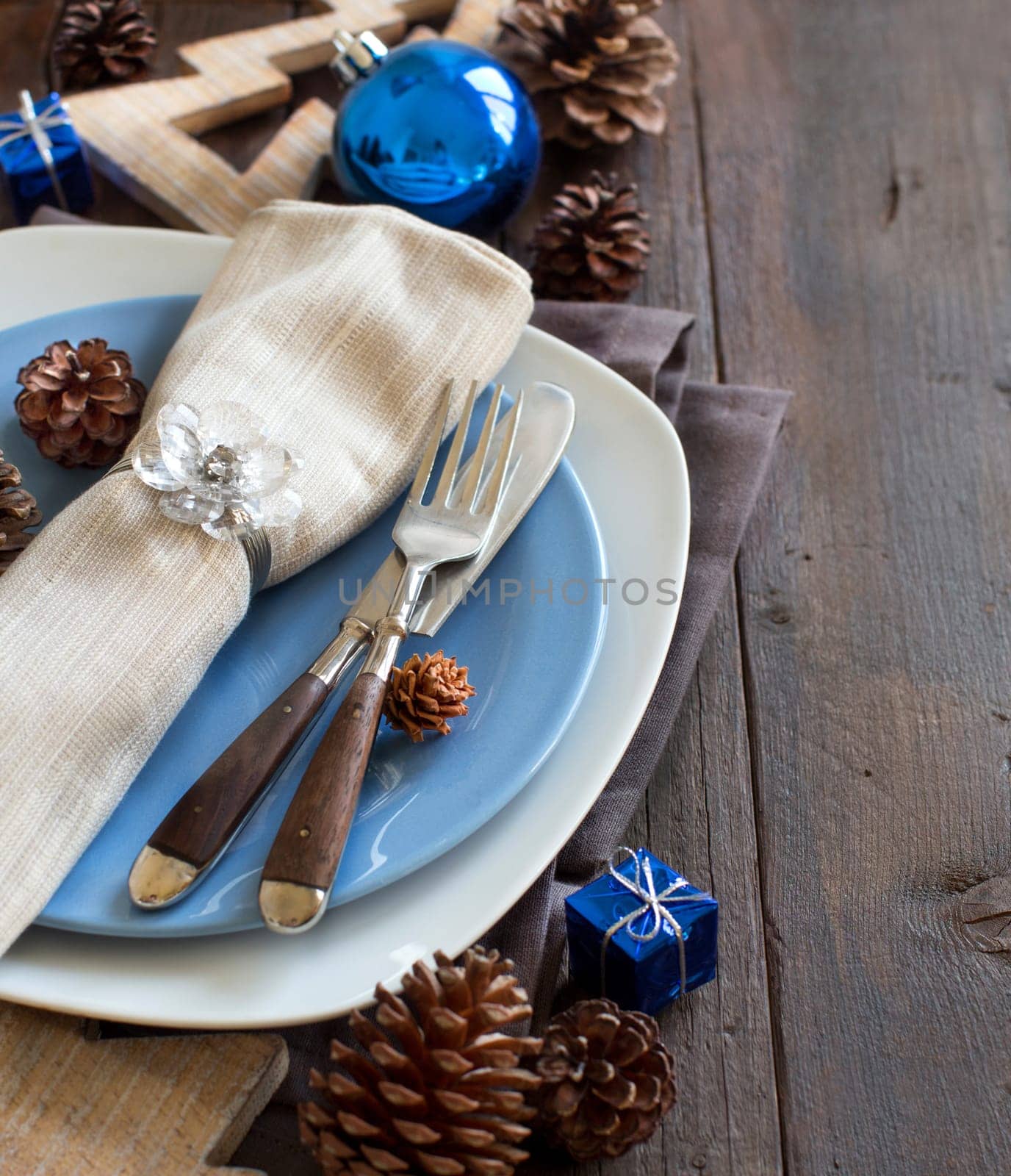 Christmas table setting with rustic decorations on wood