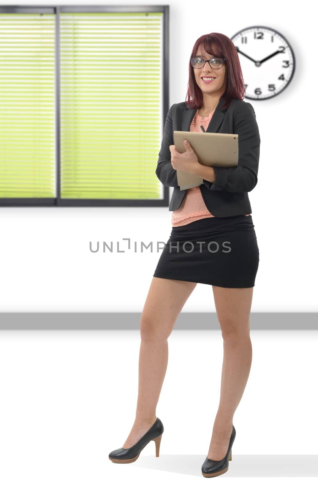 Cute young business woman smiling, in an office environment