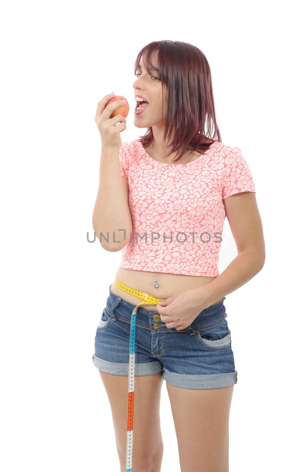 Young woman eating apple, isolated on white background