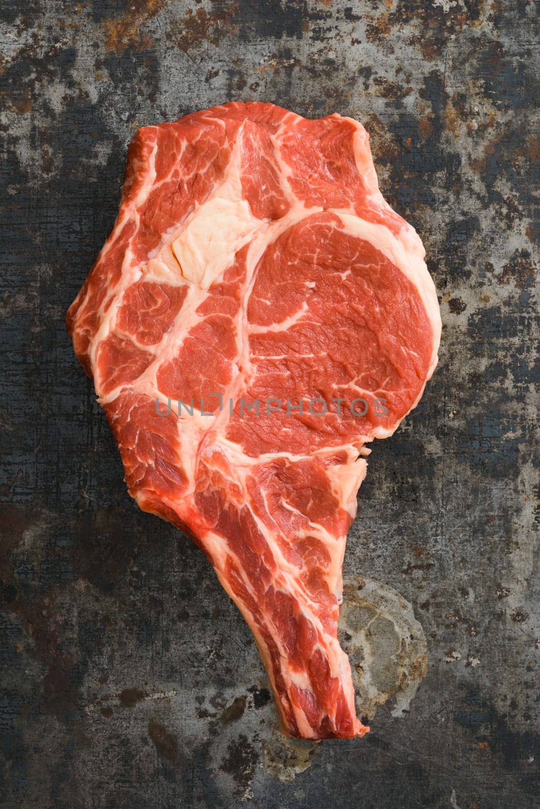 Dry aged rib eye steak on dark rustic background