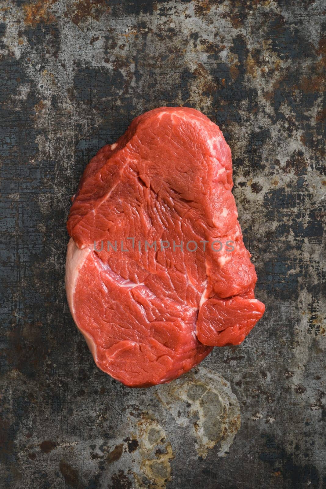 Uncooked fillet steak on dark rustic background