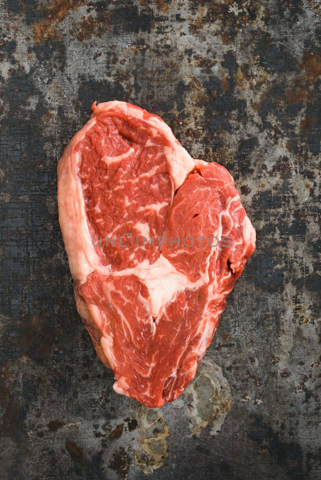 Rib eye steak on dark rustic background
