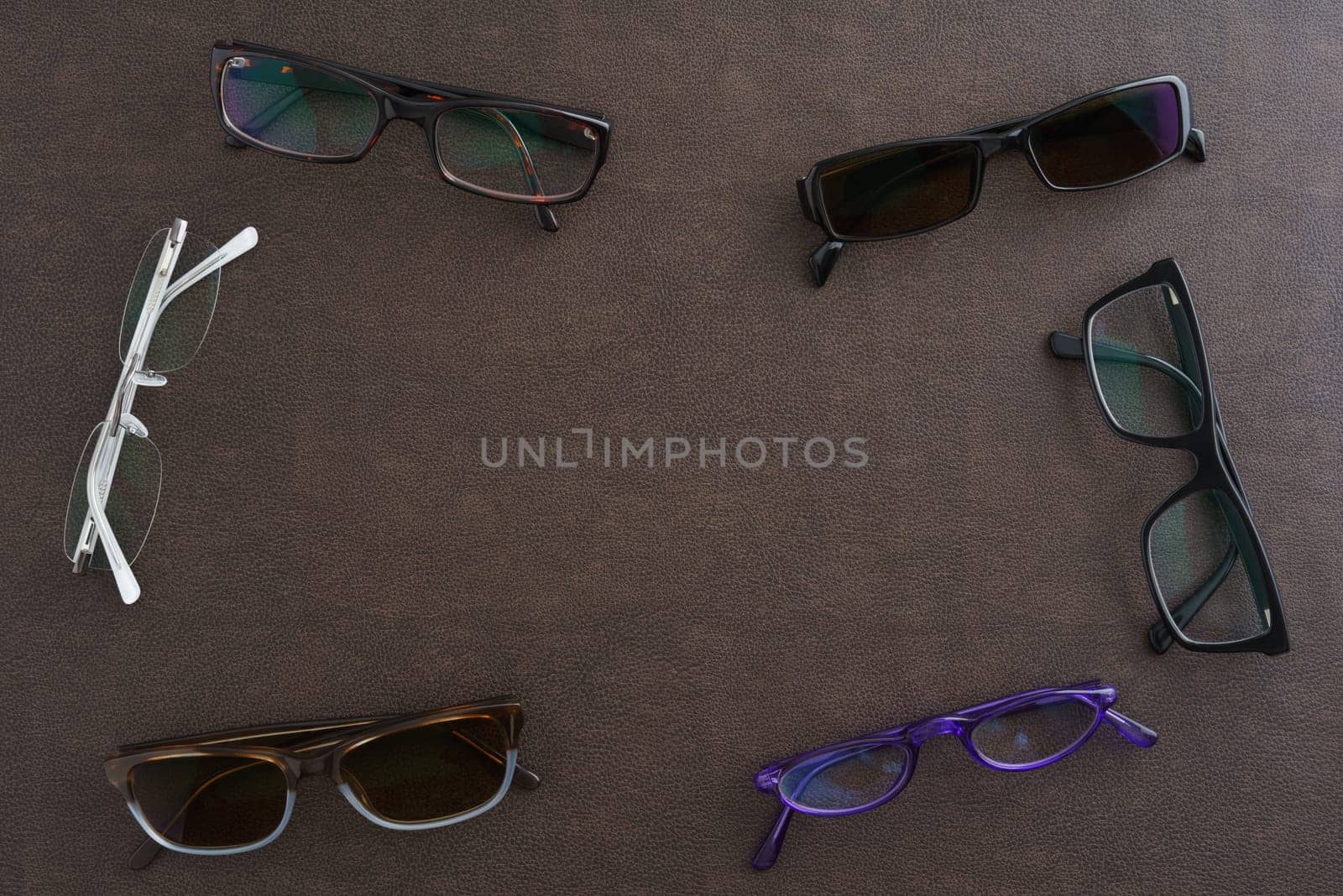 Collection of glasses and sunglasses with copyspace in the center