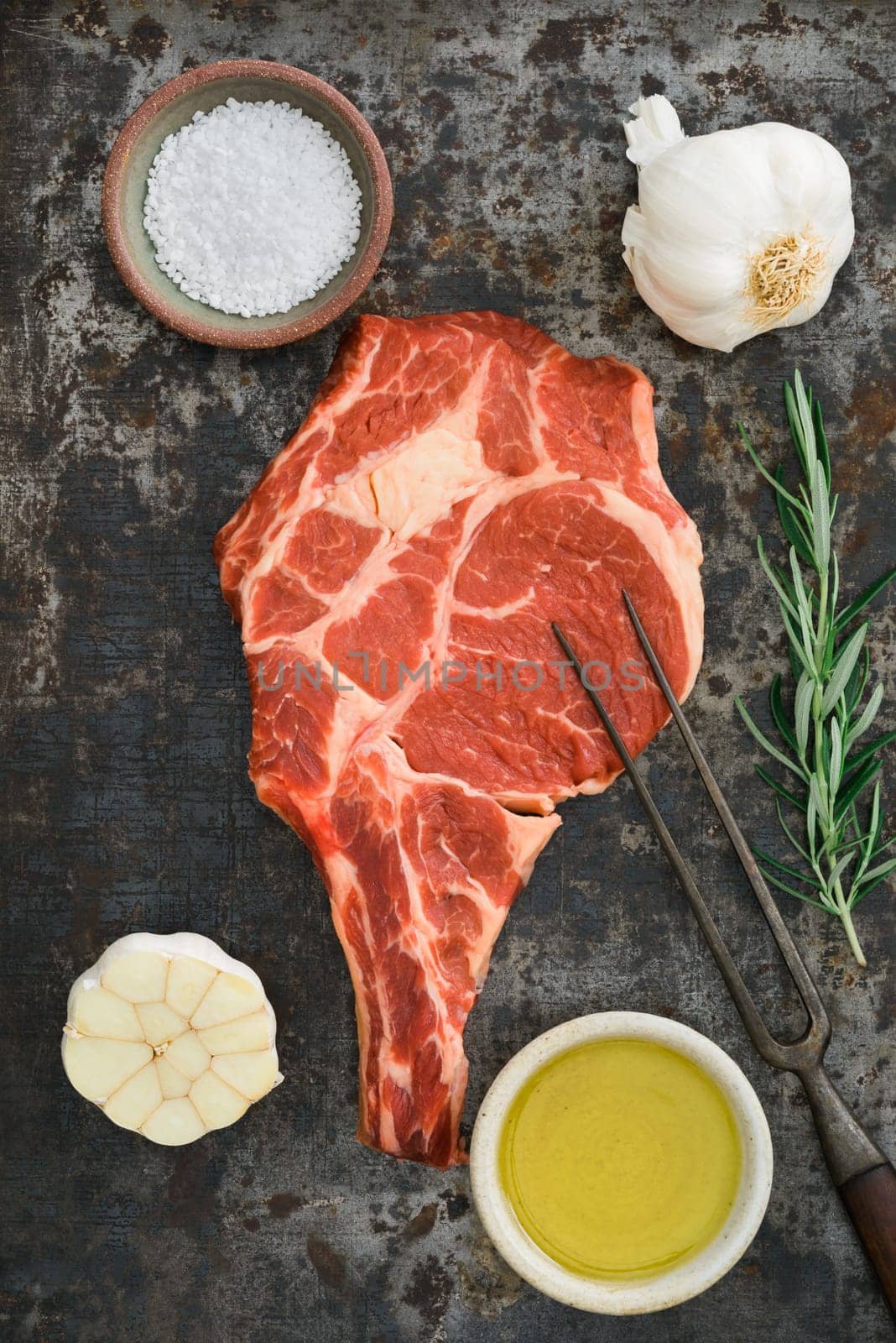Dry aged rib eye steak on dark rustic background