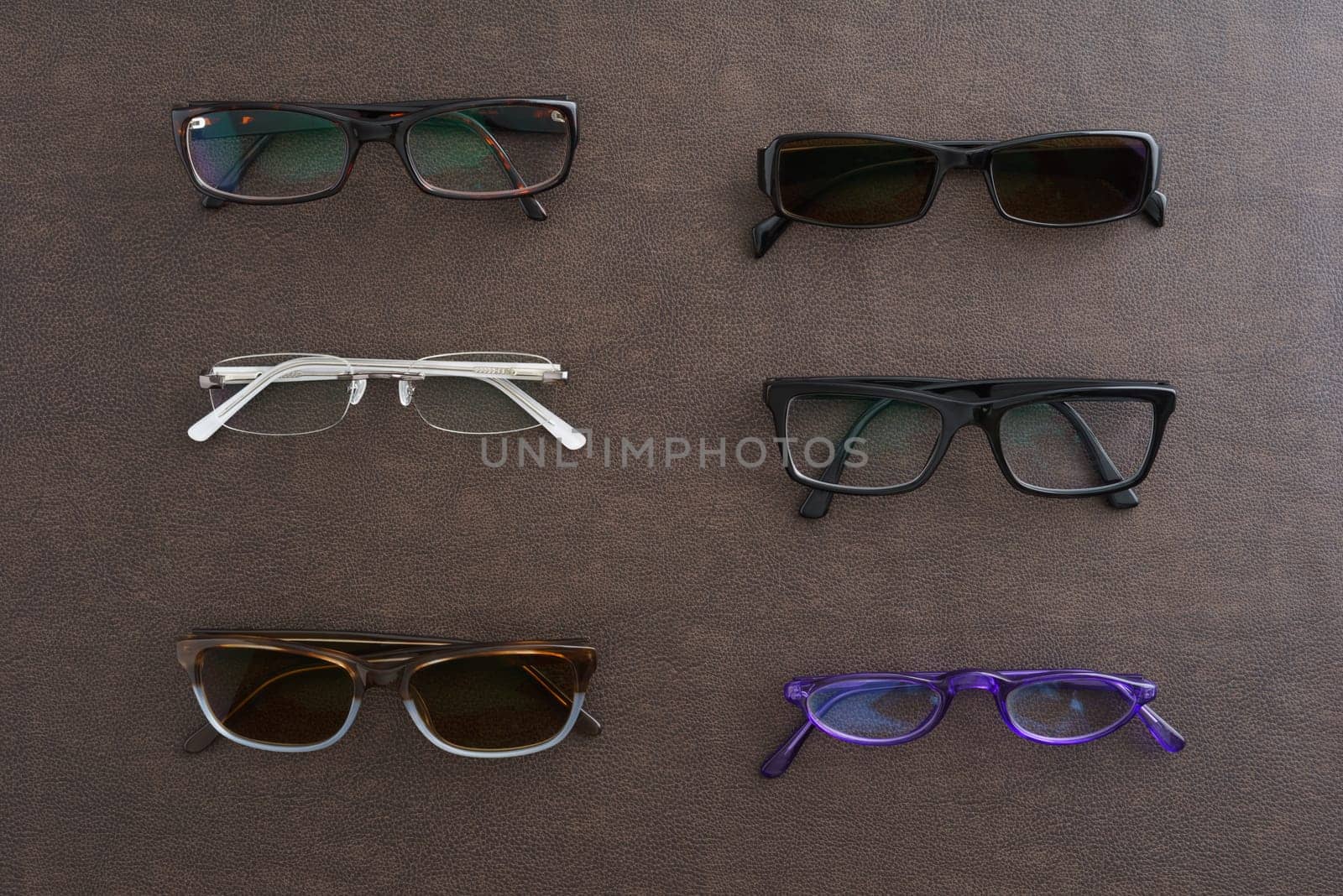 Collection of glasses and sunglasses on faux leather