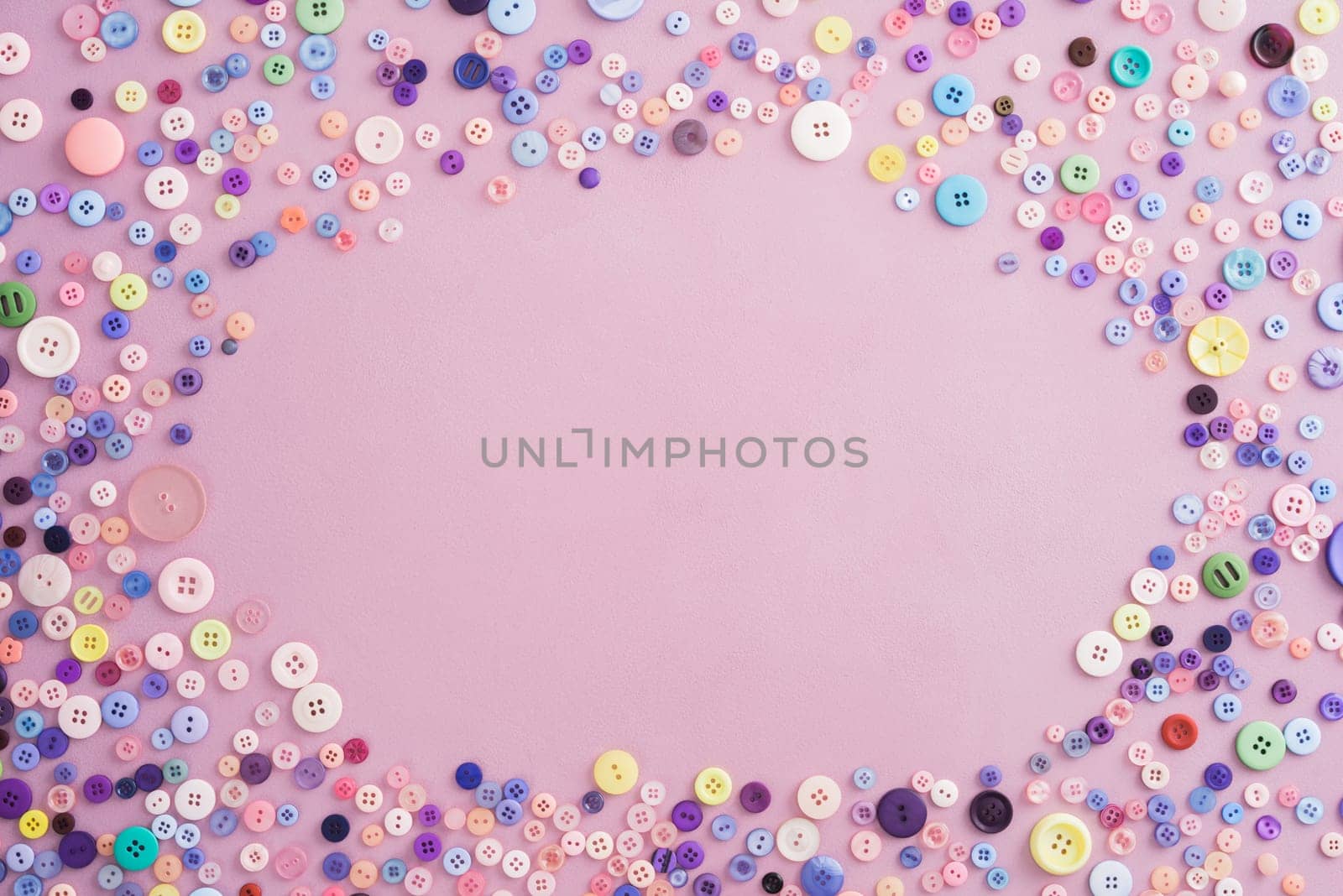 Collection of buttons in pink and pastel colours on pink background with copyspace