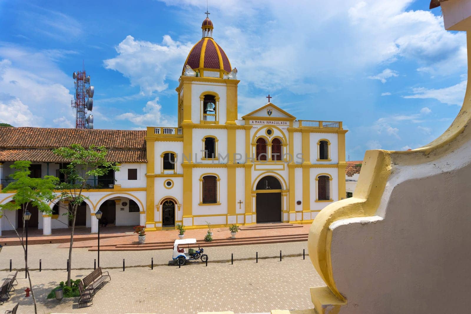 Church of the Immaculate Conception with a motor taxi parked in front in Mompox, Colombia