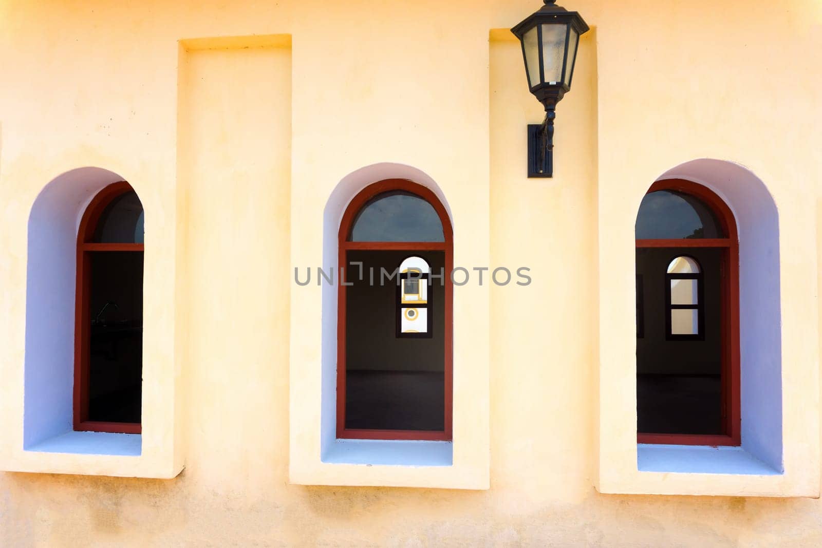 Five windows and a street light on a colonial church in Mompox, Colombia