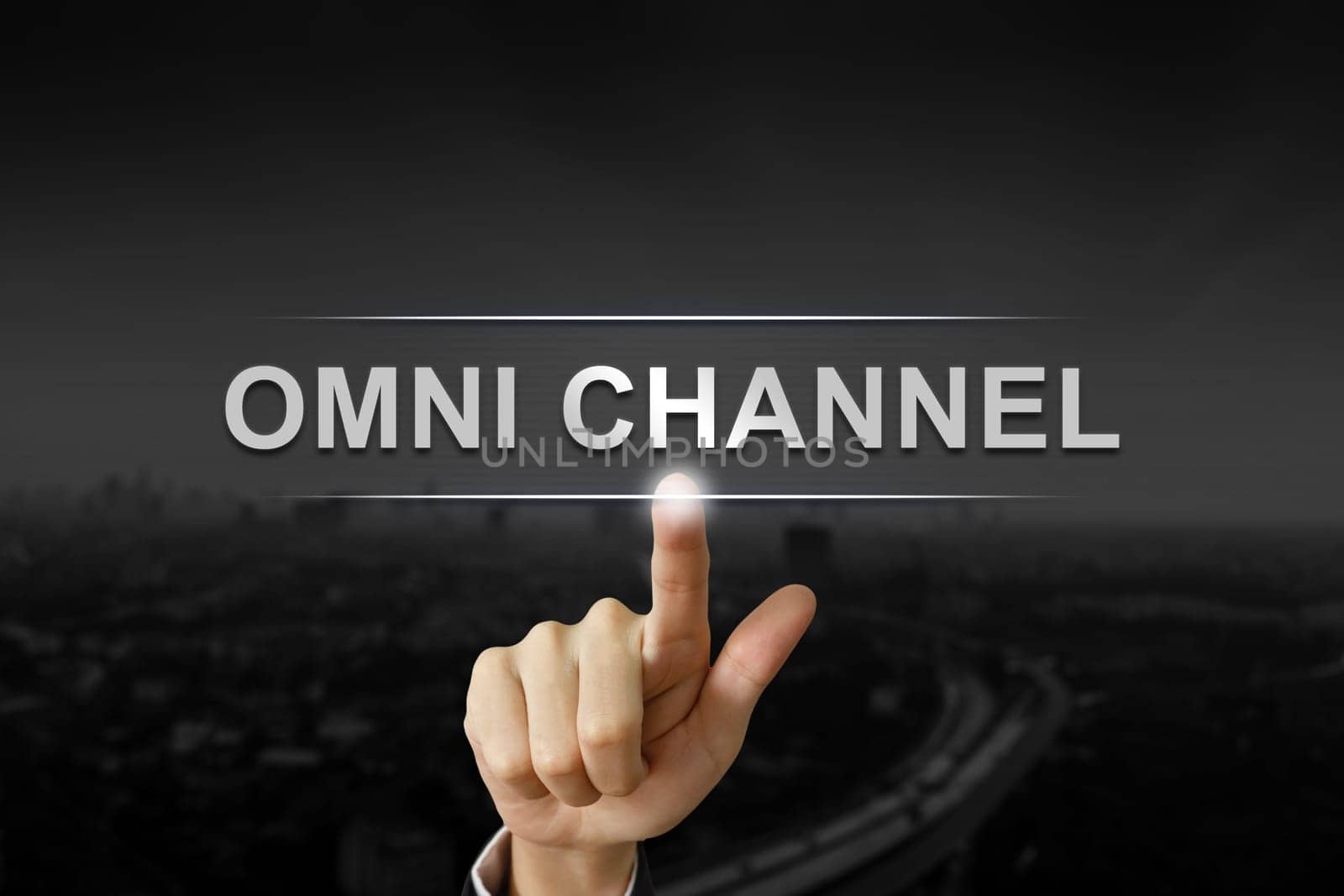 business hand clicking omni channel button on black blurred background