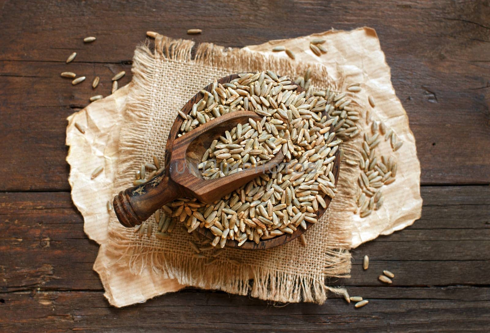 Dry Raw Rye Grain in a bowl with a spoon