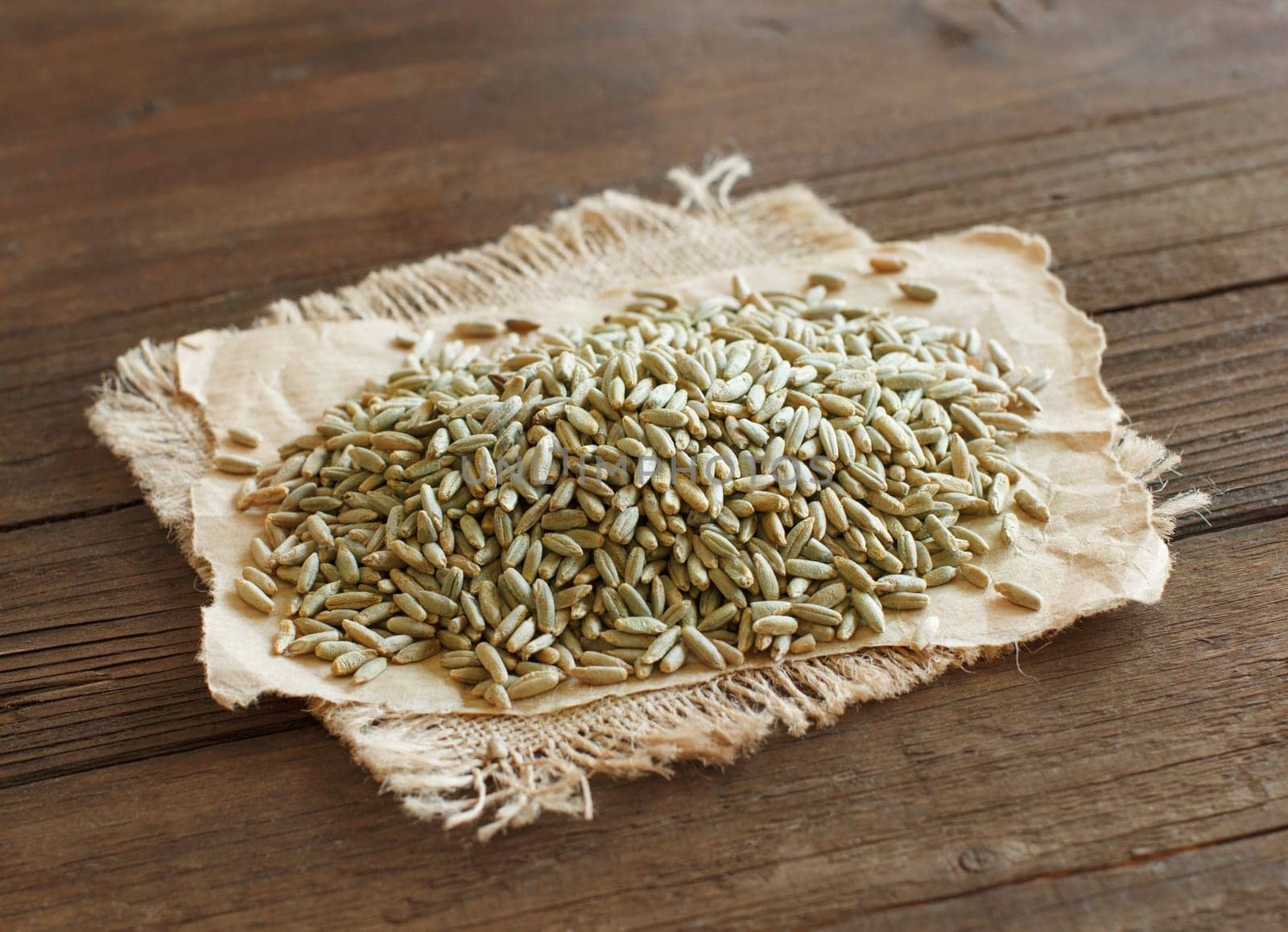 Pile of Dry Raw Rye Grain on wood