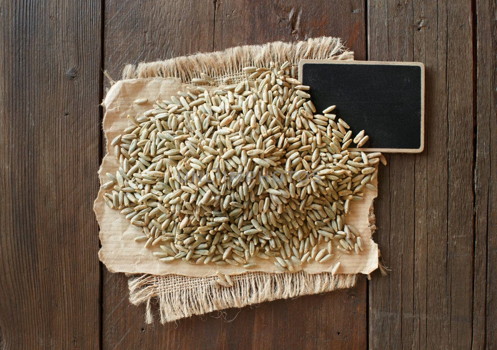Pile of Dry Raw Rye Grain with a small chalkboard