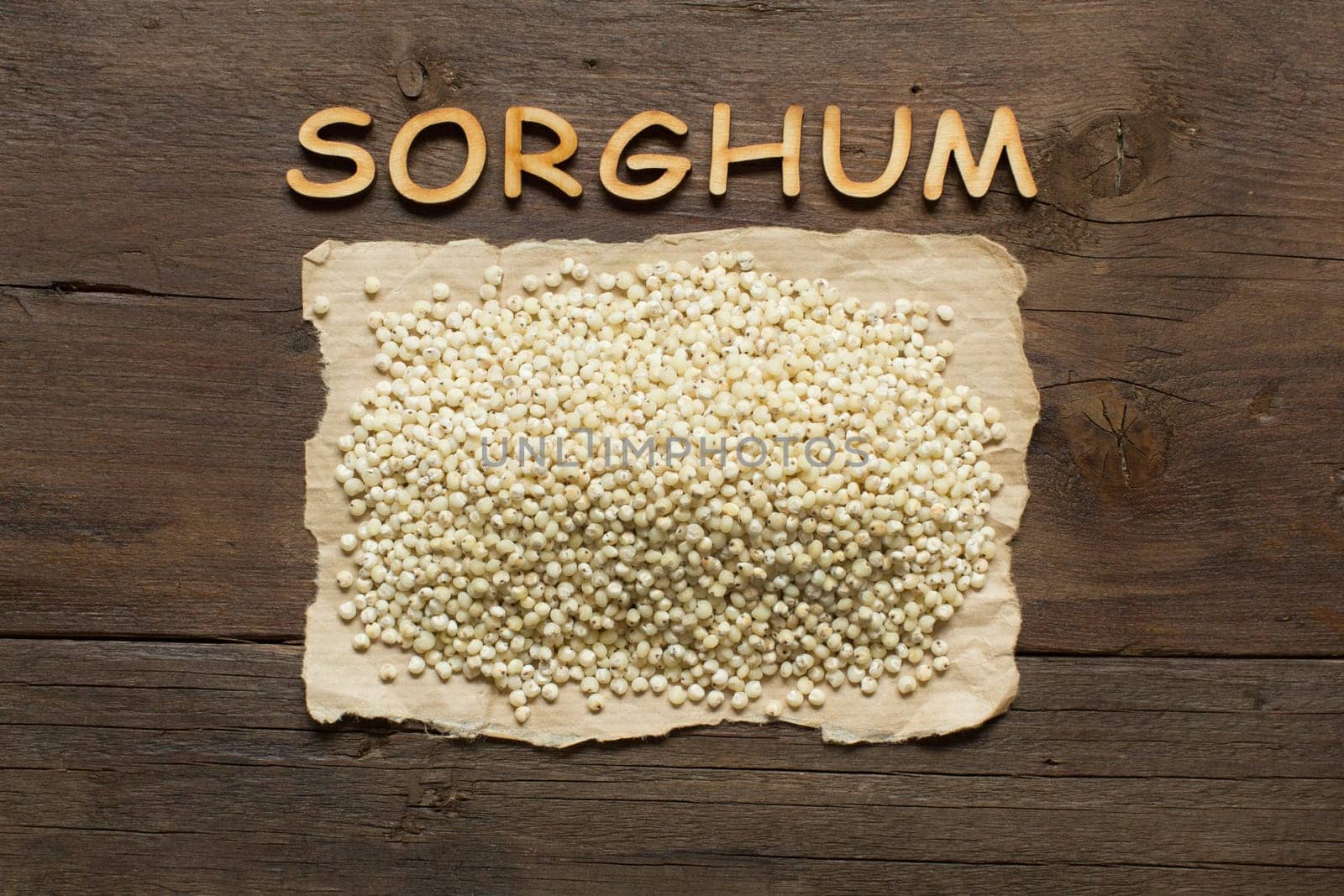 White Sorghum grain with wooden letters on the wooden table