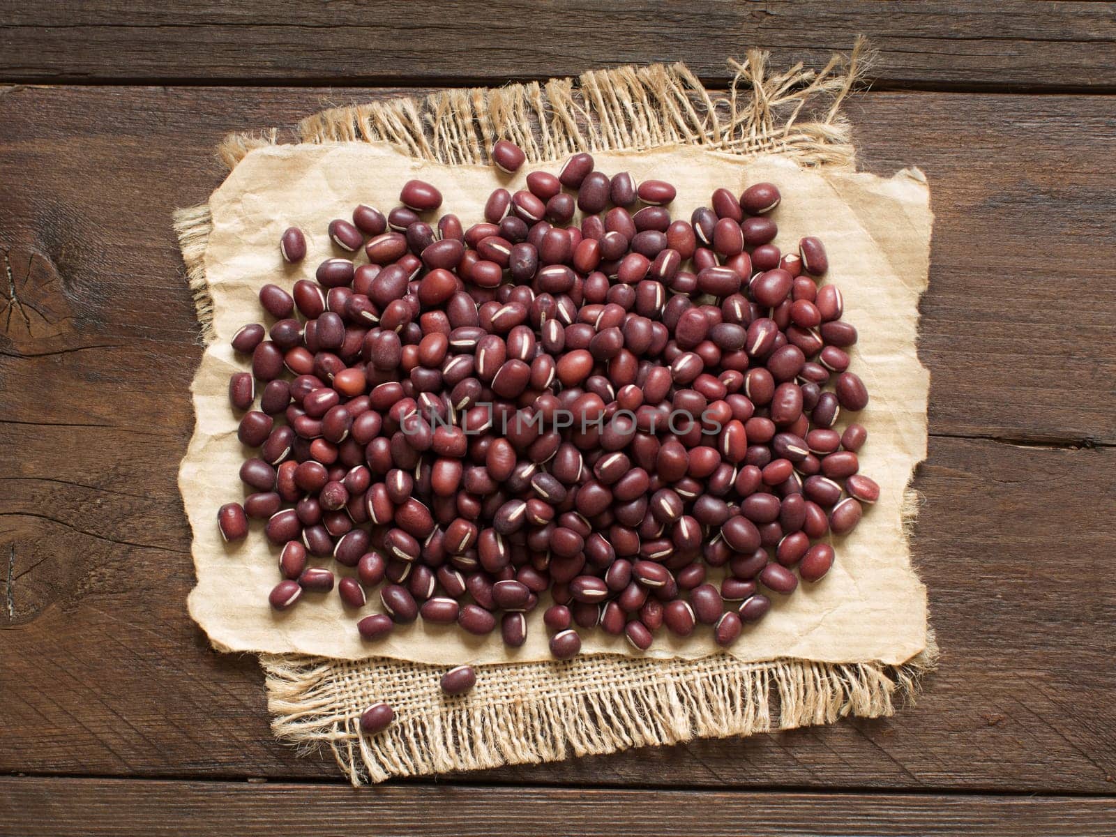 Uncooked azuki beans on a wooden table close up