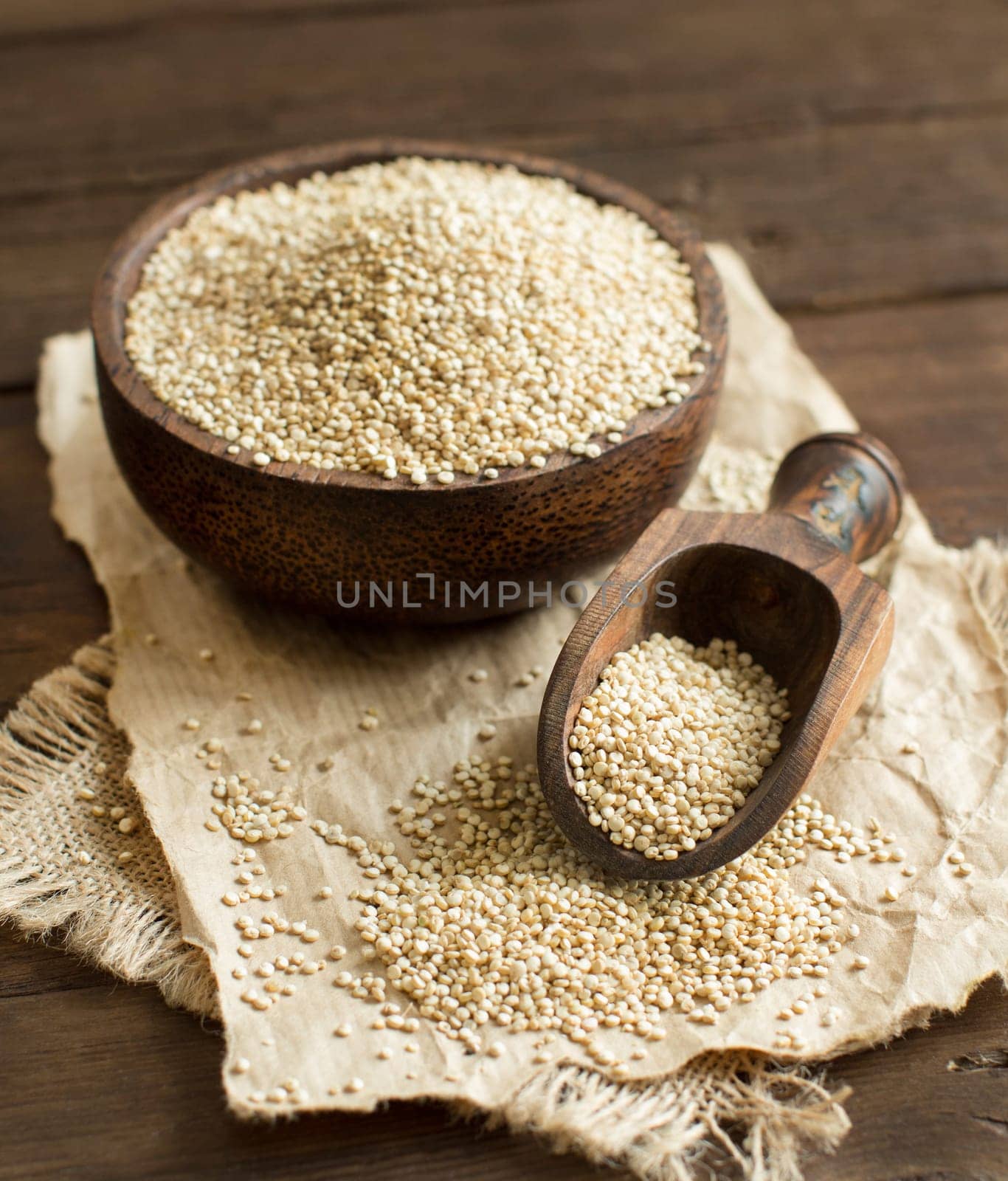 White Quinoa in a bowl with a wooden spoon close up