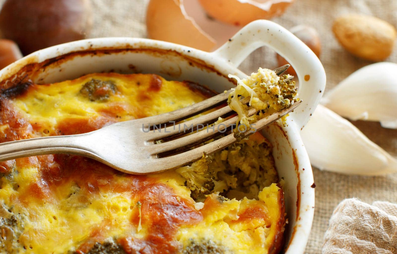 Casserole with broccoli on a rustic background closeup