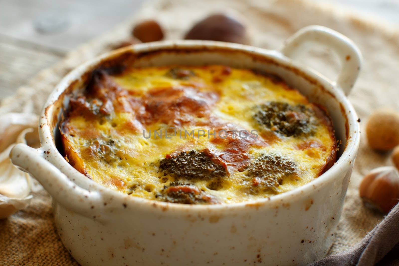 Casserole with broccoli on a rustic background closeup