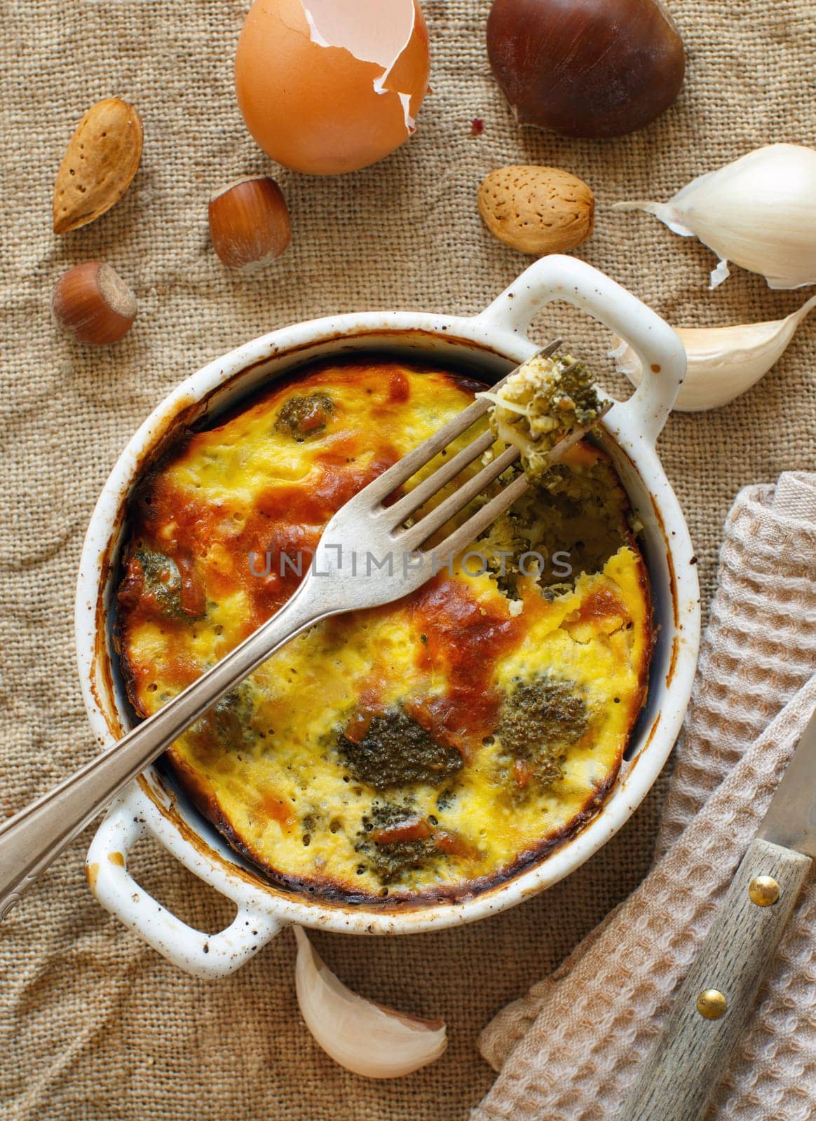 Casserole with broccoli on a rustic background closeup