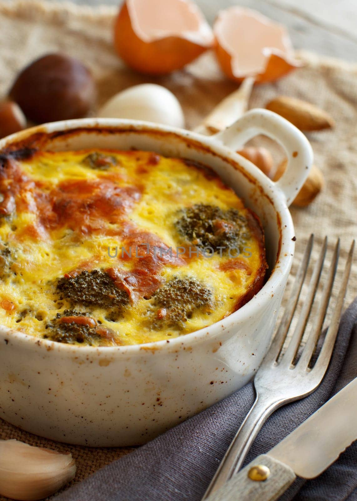 Casserole with broccoli on a rustic background closeup