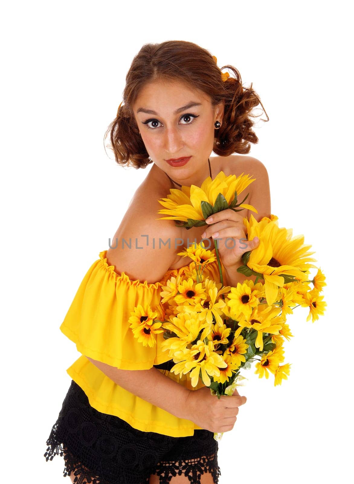 Gorgeous young woman in a yellow blouse holding a bunch of .sunflowers, standing isolated for white background..