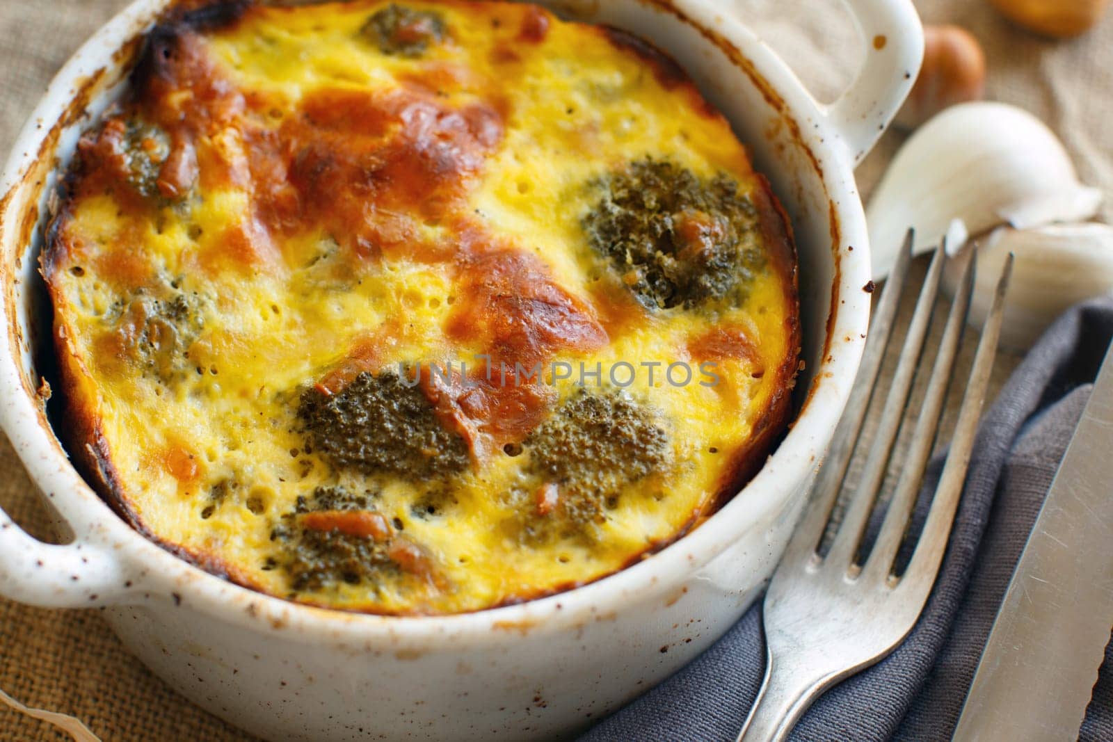 Casserole with broccoli on a rustic background closeup
