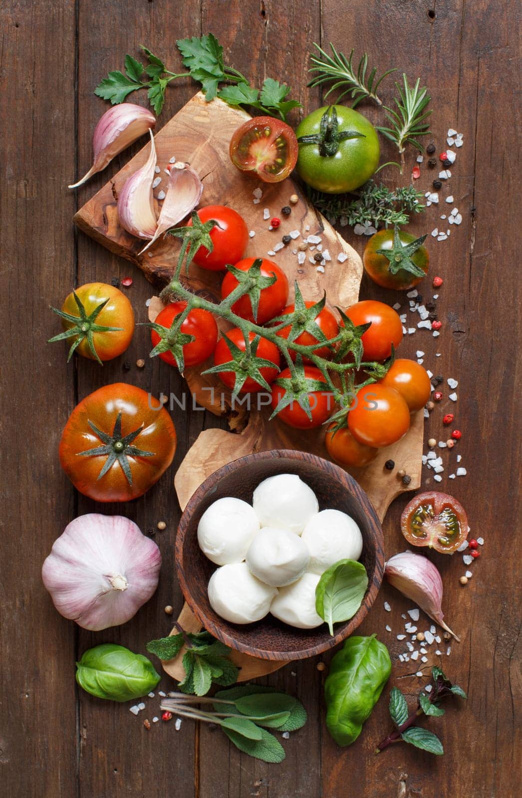 Italian cooking ingredients : mozzarella, tomatoes, garlic, herbs and other