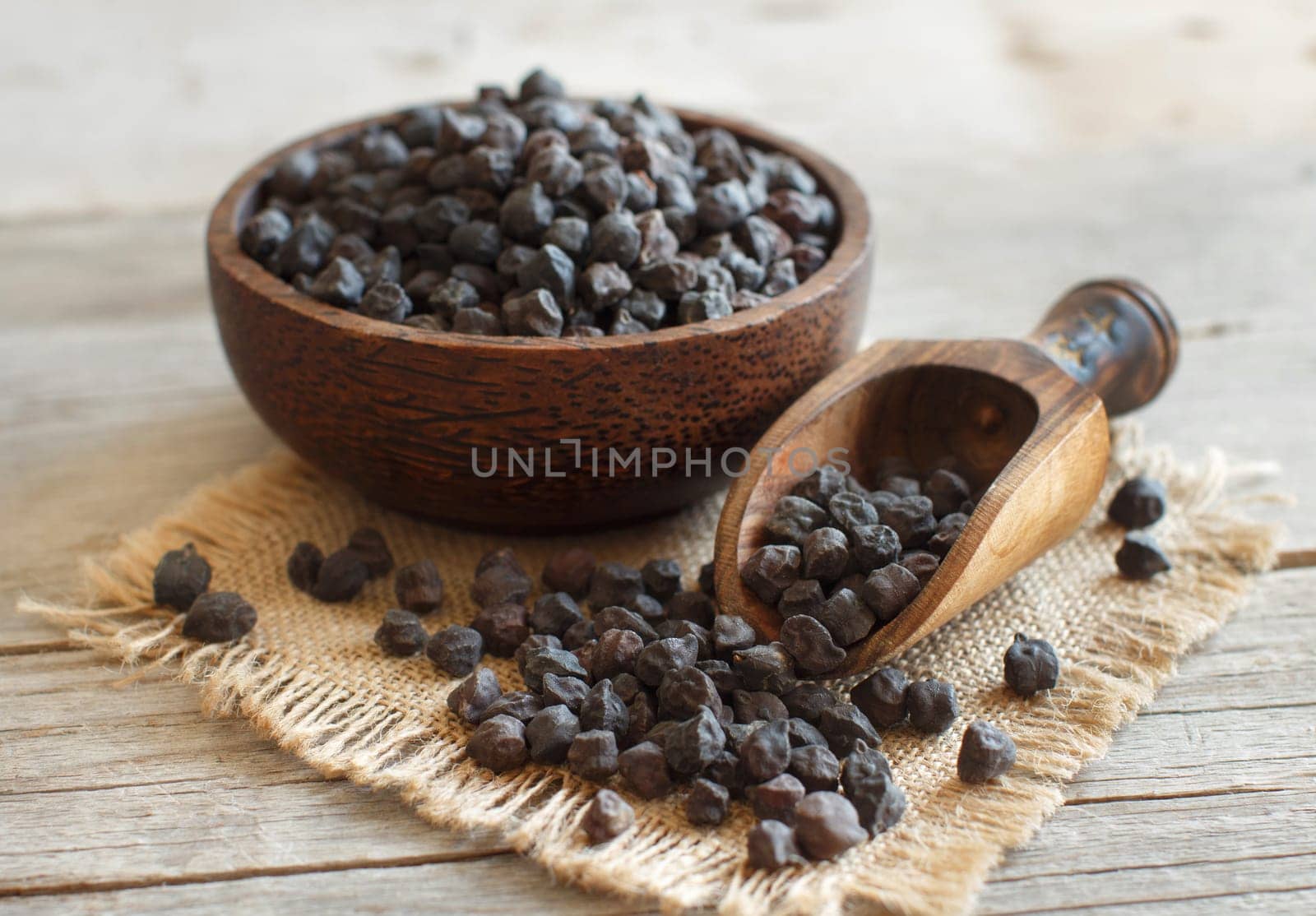 Black Chickpea in a bowl with a spoon on a wooden table