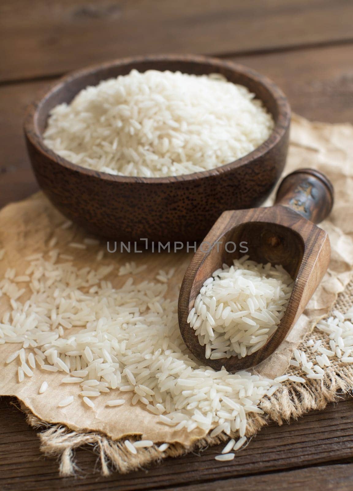 Pile of Basmati rice in a bowl with a spoon close up