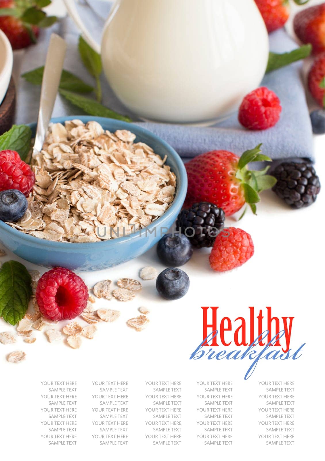 Rolled oats in a bowl with berries and milk isolated on white