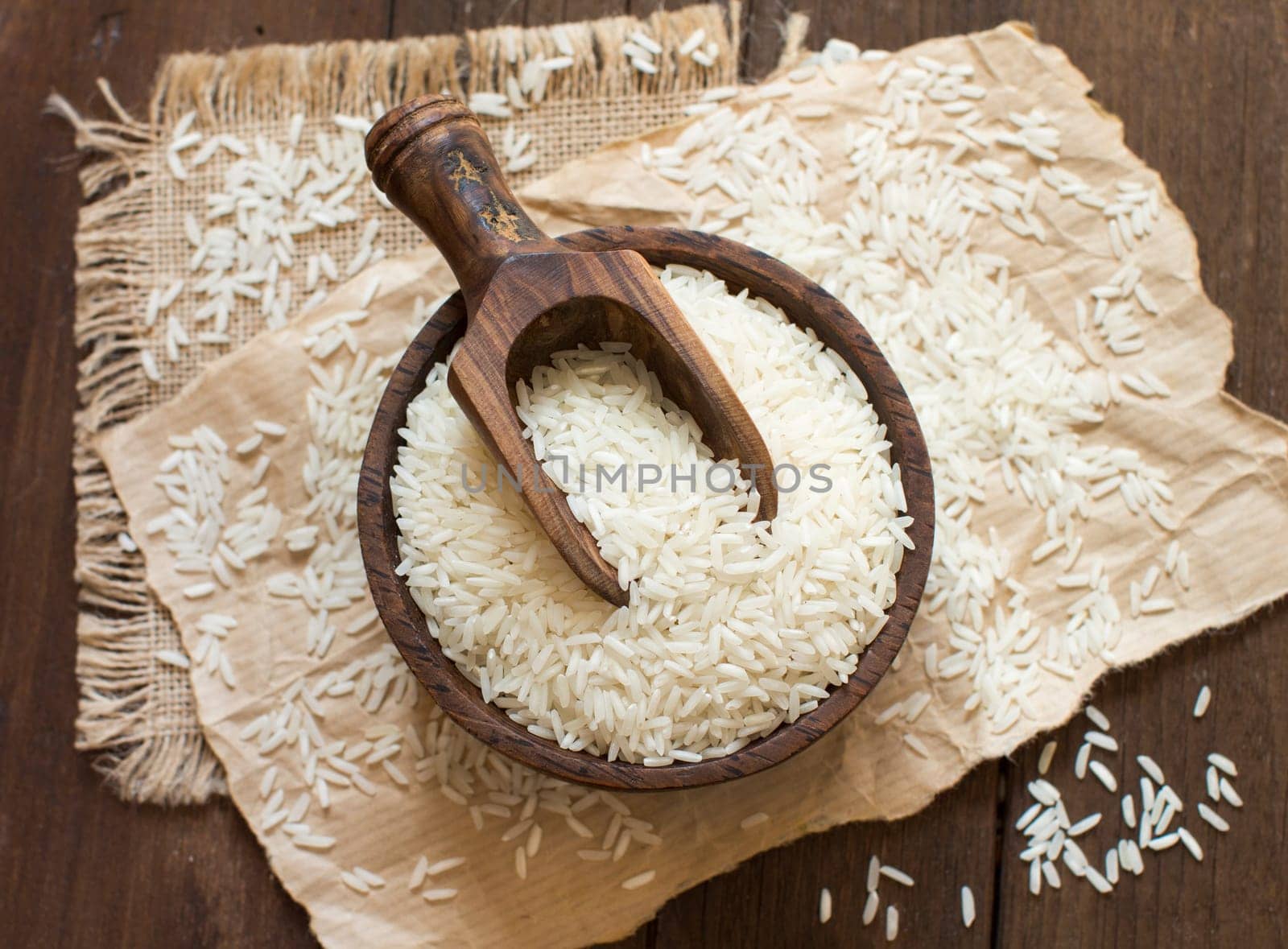 Pile of Basmati rice in a bowl with a spoon close up