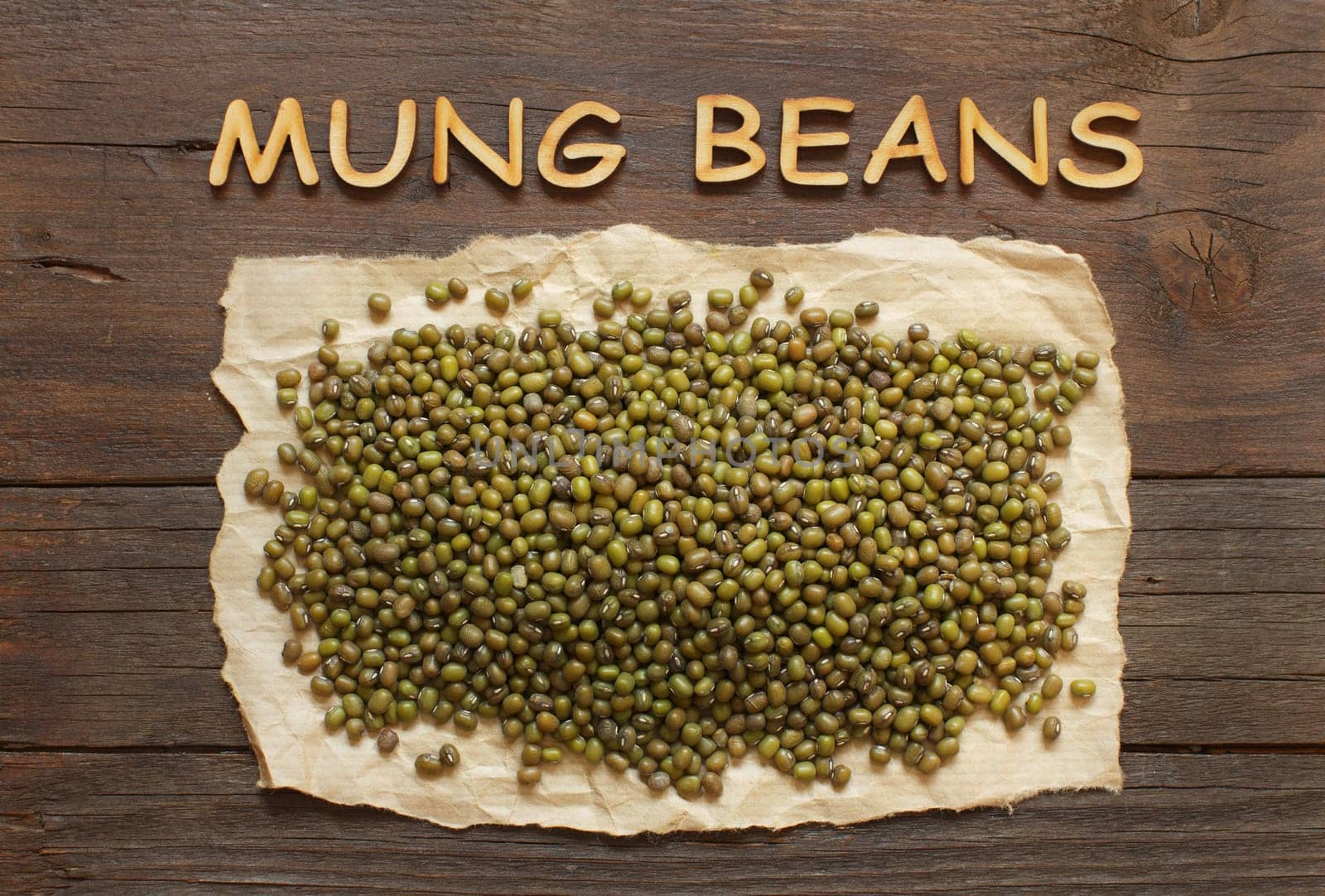 Raw Mung beans with wodden letters top view