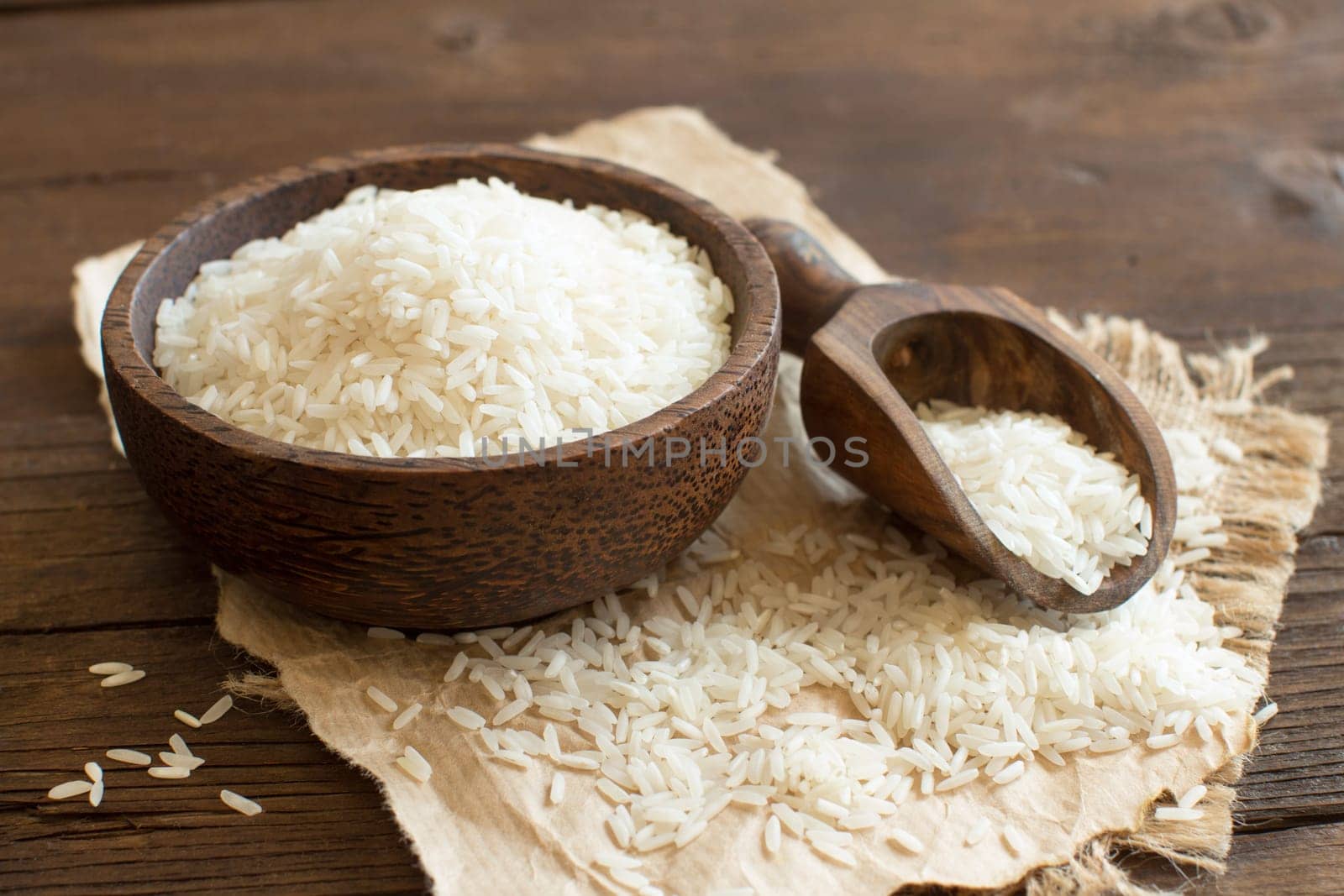 Pile of Basmati rice in a bowl with a spoon close up