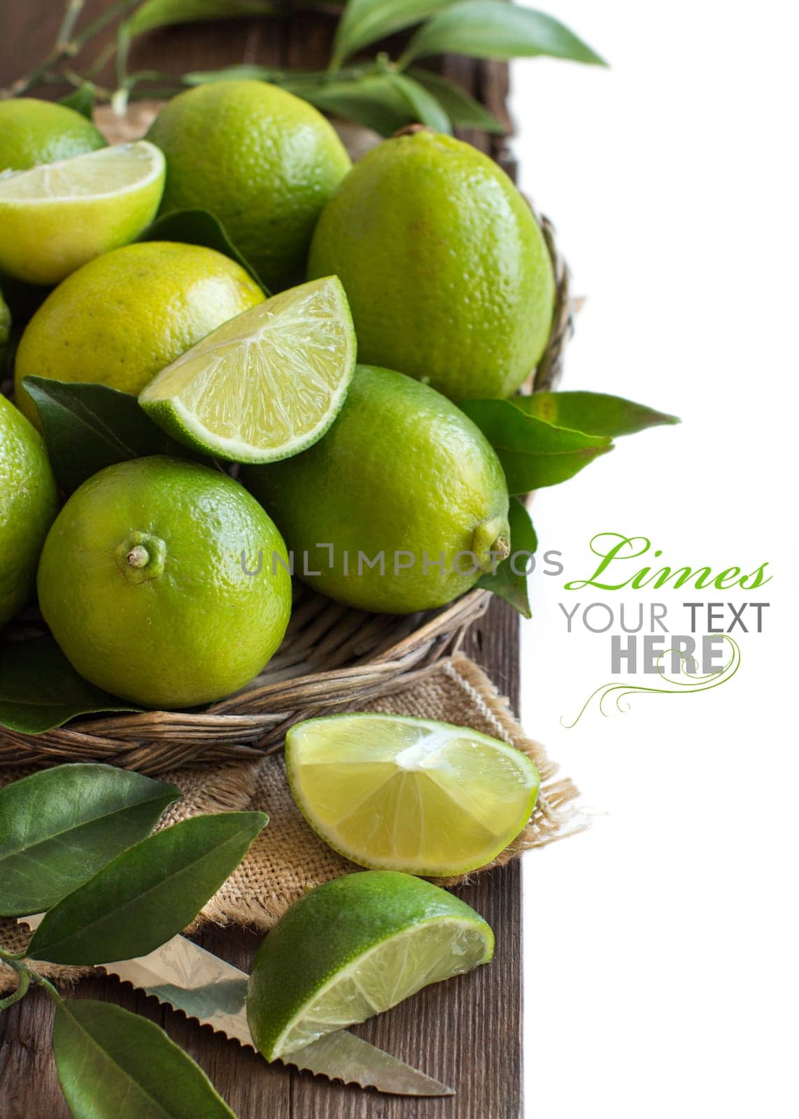 Fresh limes with leaves on a wooden table