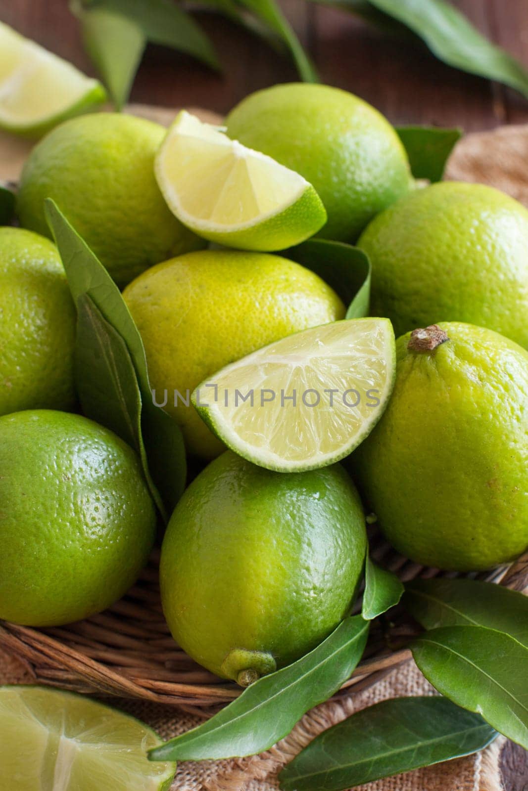 Fresh limes with leaves on a wooden table