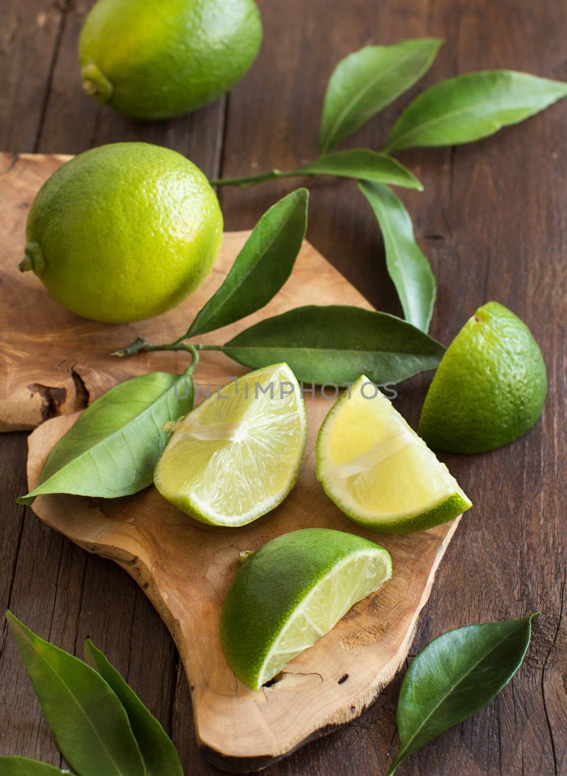Fresh limes with leaves on a wooden table