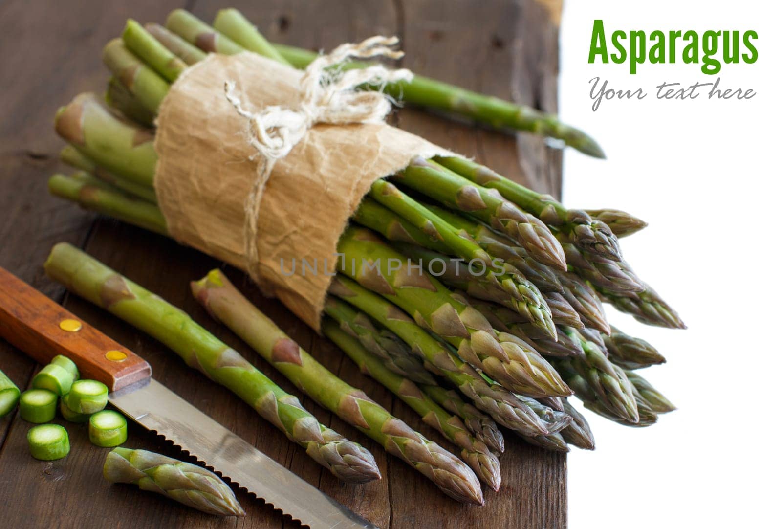 Fresh asparagus with knife on a wooden table
