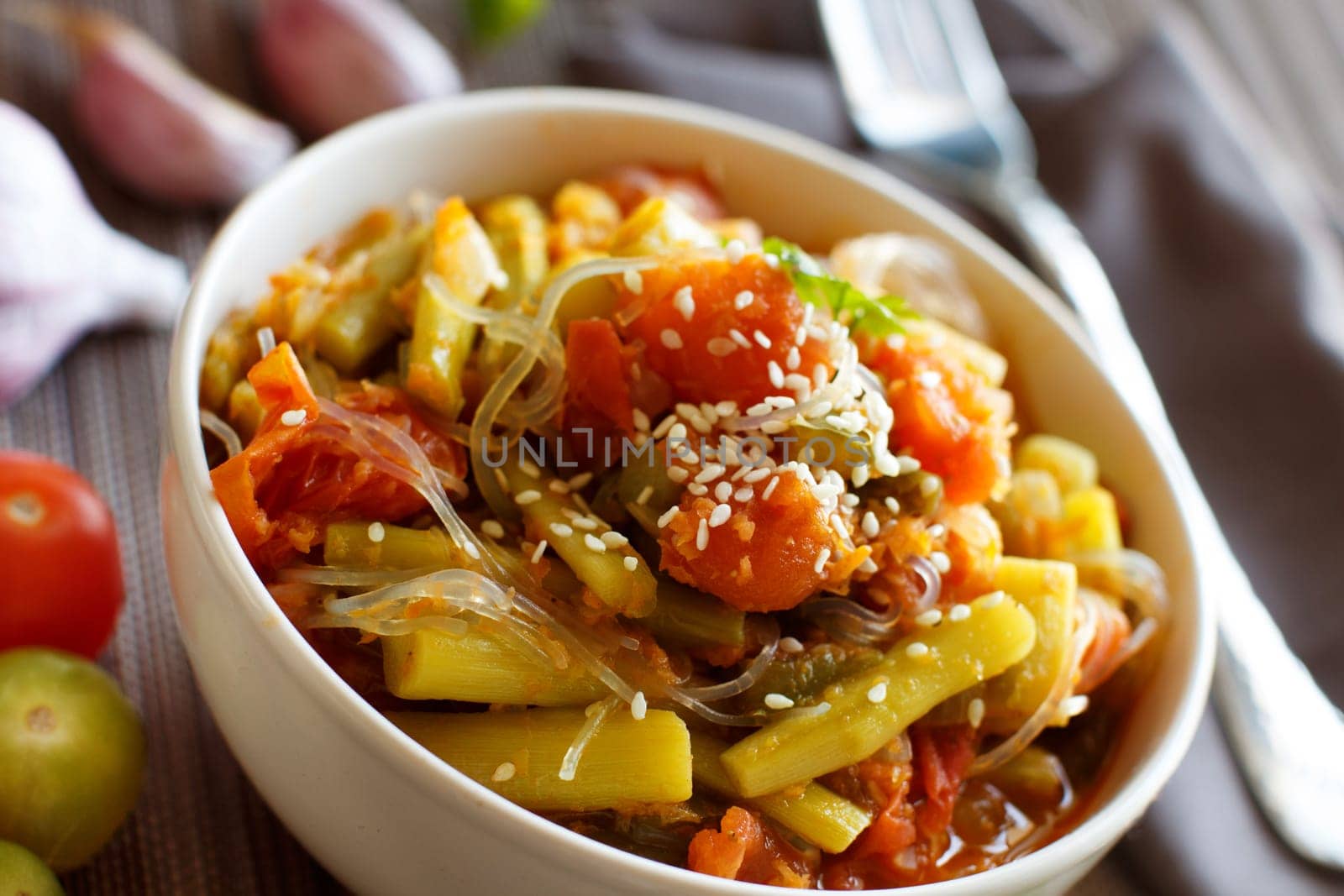 Rice spaghetti with vegetables in a bowl close up