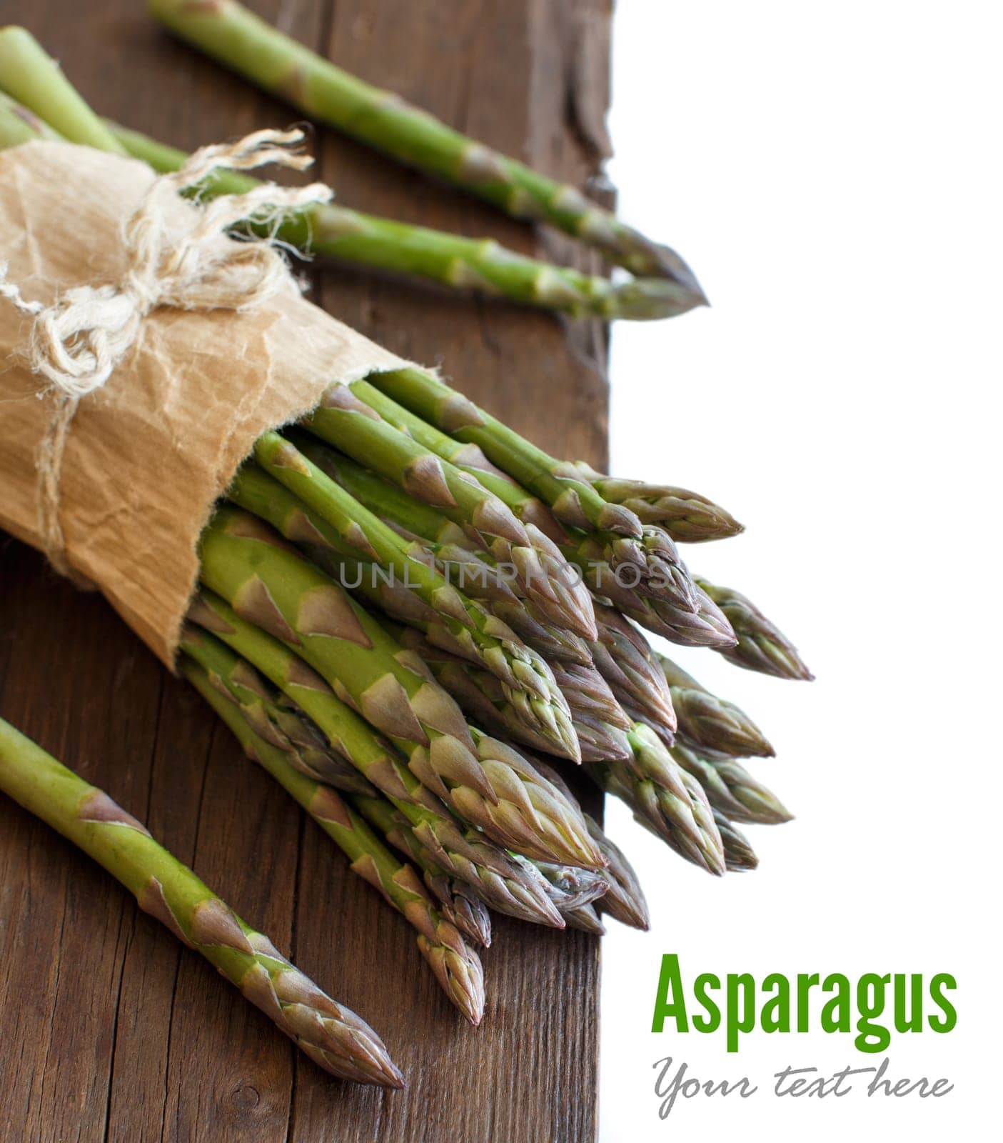 Fresh asparagus spears on a wooden table close up
