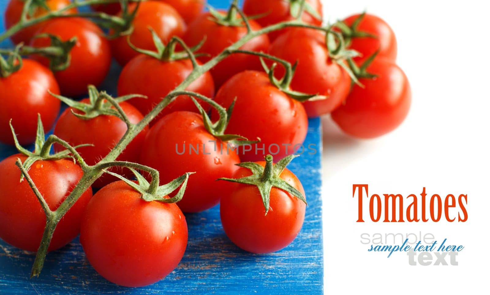 Cherry tomatoes on the old blue wooden background