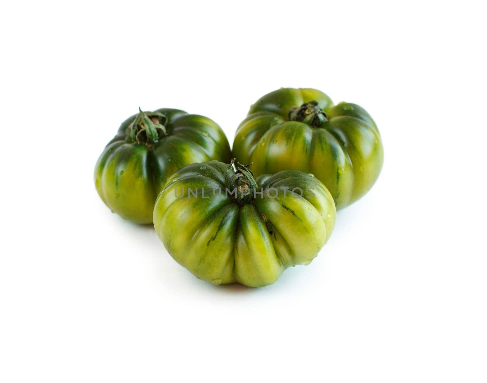 Fresh green costoluto tomatoes isolated on white background