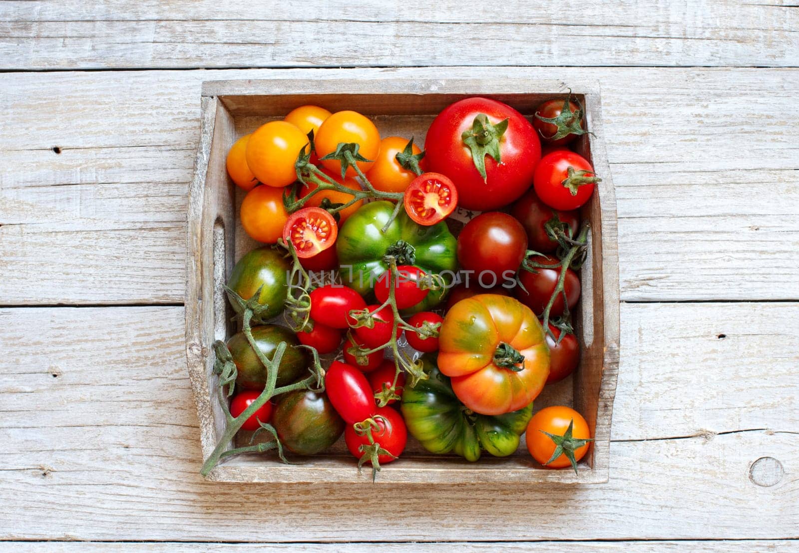 Colorful tomatoes on a wooden table top view