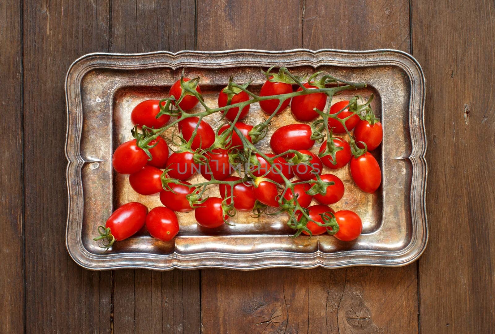 Cherry tomatoes on a metal tray top view