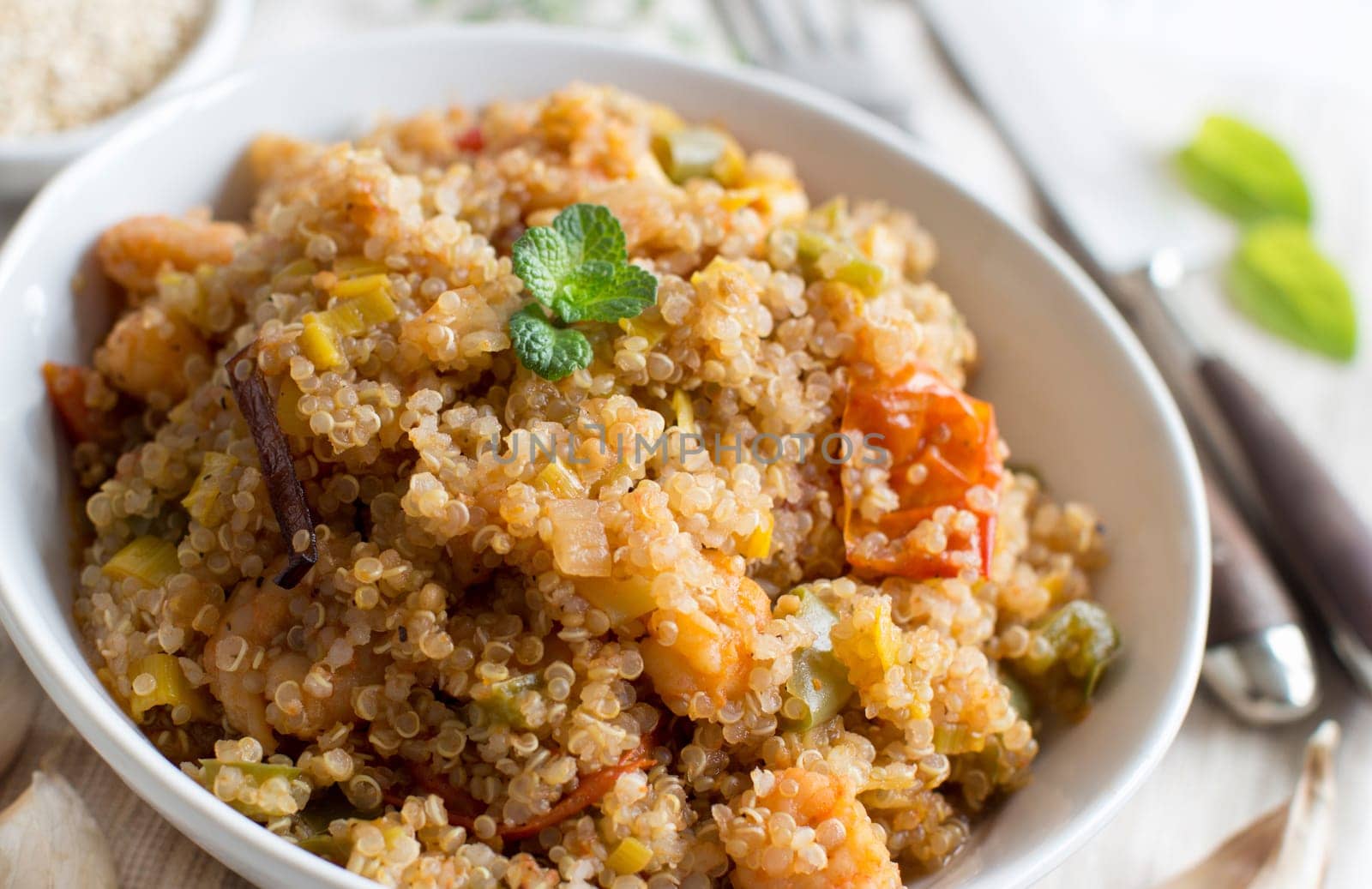 Cooked Quinoa with vegetables and shrimps in a bowl