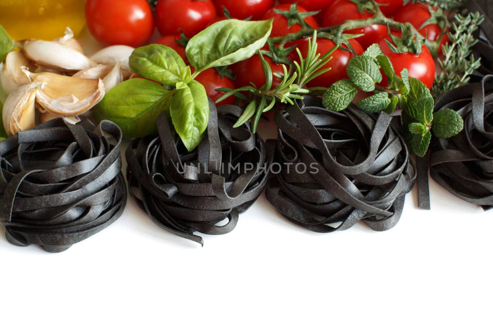 Black Tagliatelle pasta with cherry tomatoes, garlic and herbs