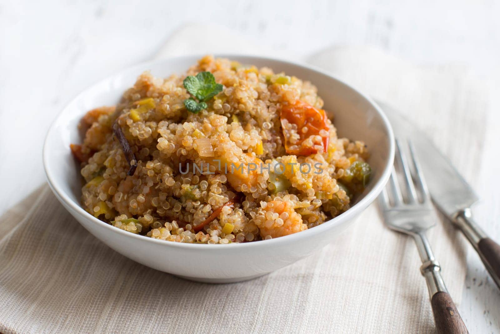 Cooked Quinoa with vegetables and shrimps in a bowl