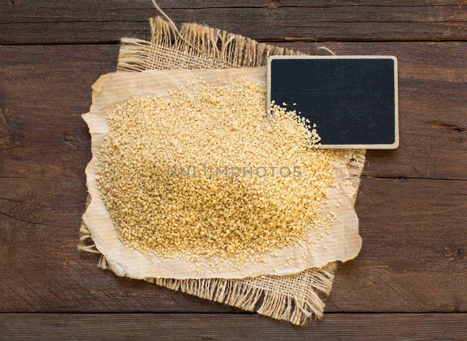 Pile of whole wheat CousCous with a small chalkboard